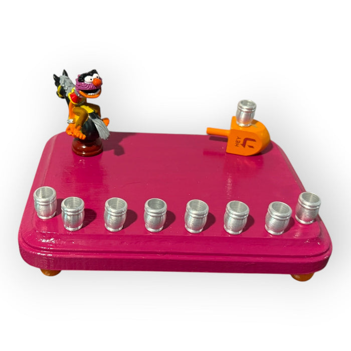 Animal Muppets menorah — wild-haired drummer chess figure above aluminum candle cups | Judaica Square Lakewood