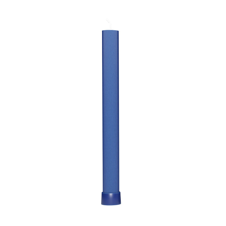 Navy blue fluted pillar Havdalah candle standing upright on white