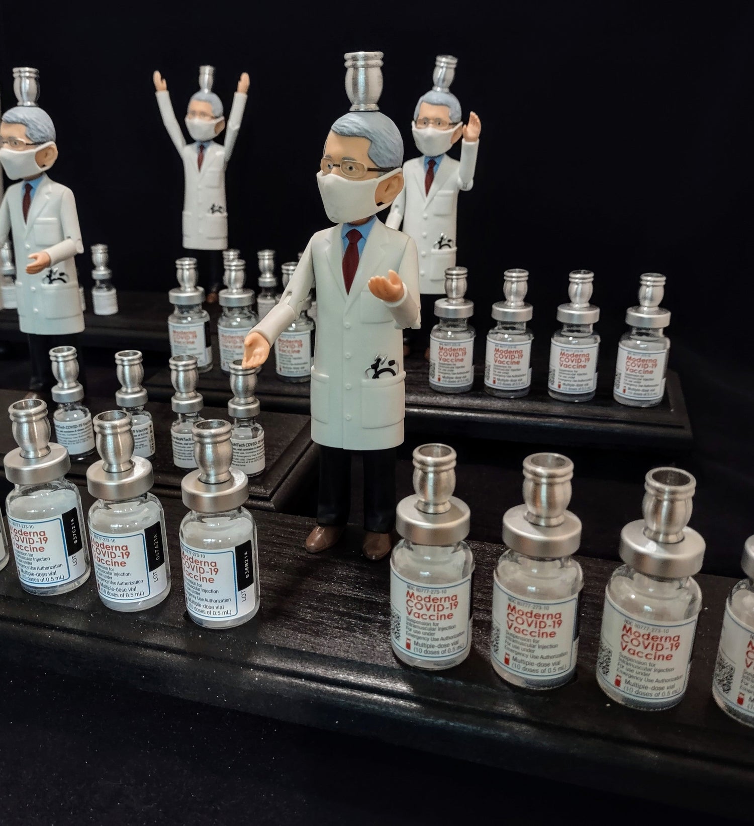Dr. Fauci Vaccine Menorah — action figure beside repurposed glass vaccine vials | Judaica Square Lakewood (view 2)