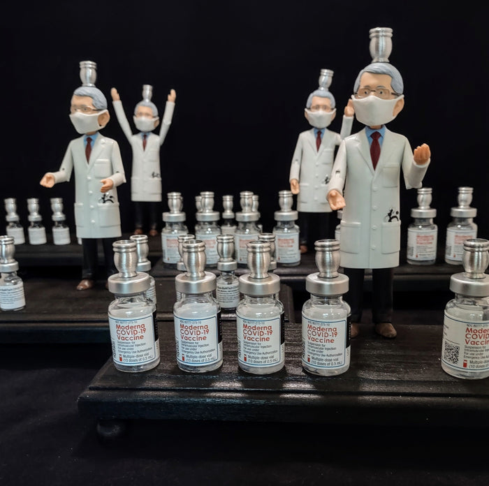 Dr. Fauci Vaccine Menorah — action figure beside repurposed glass vaccine vials | Judaica Square Lakewood