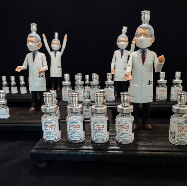 Dr. Fauci Vaccine Menorah — action figure beside repurposed glass vaccine vials | Judaica Square Lakewood