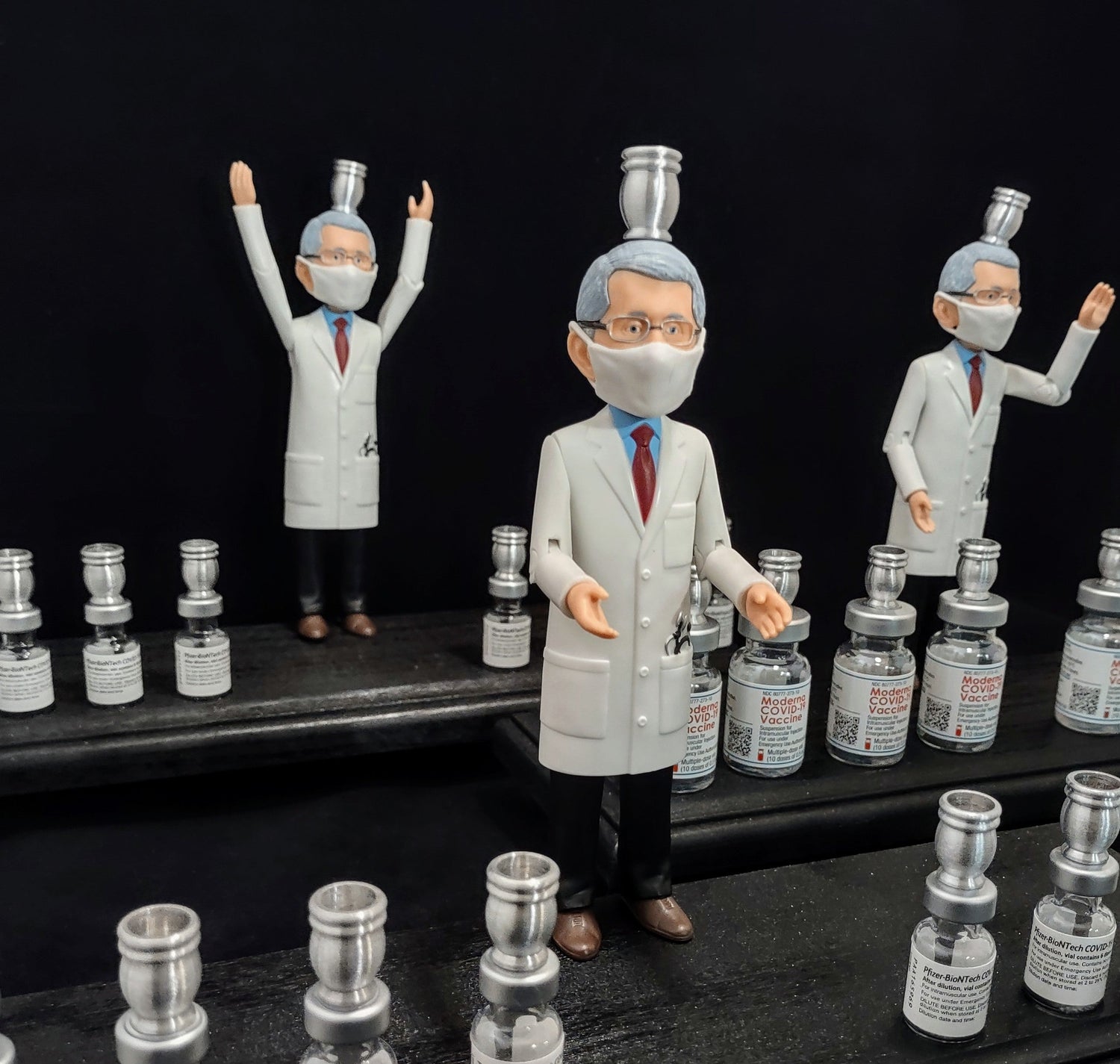 Dr. Fauci Vaccine Menorah — action figure beside repurposed glass vaccine vials | Judaica Square Lakewood (view 6)