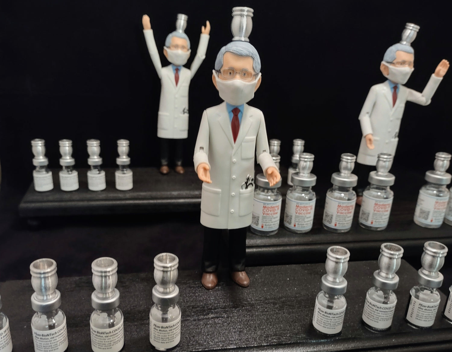 Dr. Fauci Vaccine Menorah — action figure beside repurposed glass vaccine vials | Judaica Square Lakewood (view 7)
