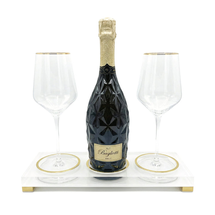 Marble-print acrylic tray on gold legs holding a bottle and two gold-rimmed glasses