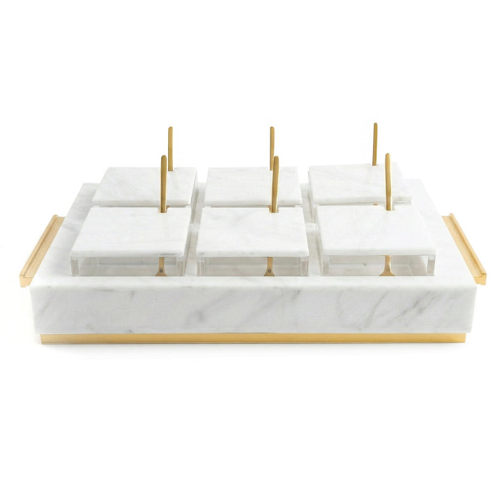 White marble lucite six-bowl dip set with lids on and gold spoons upright
