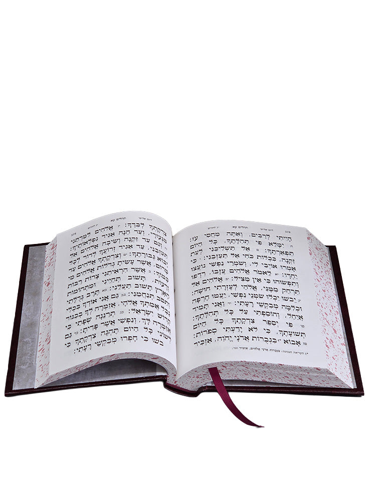 Open to the larger-print Tehillim pages, with ribbon marker and speckled page edges