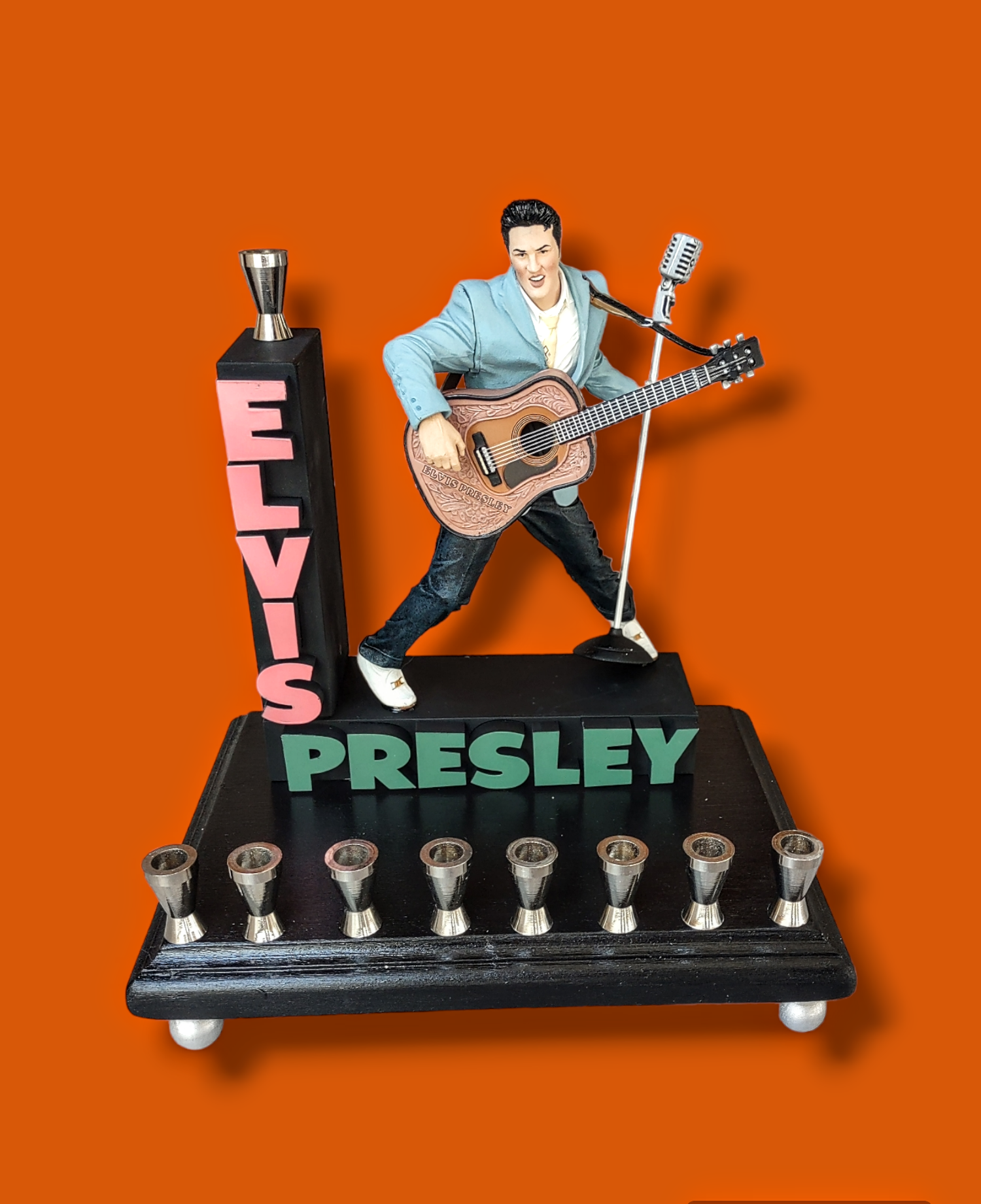 Elvis marquee menorah — King figure at the mic under a stacked name marquee | Judaica Square Lakewood (view 2)