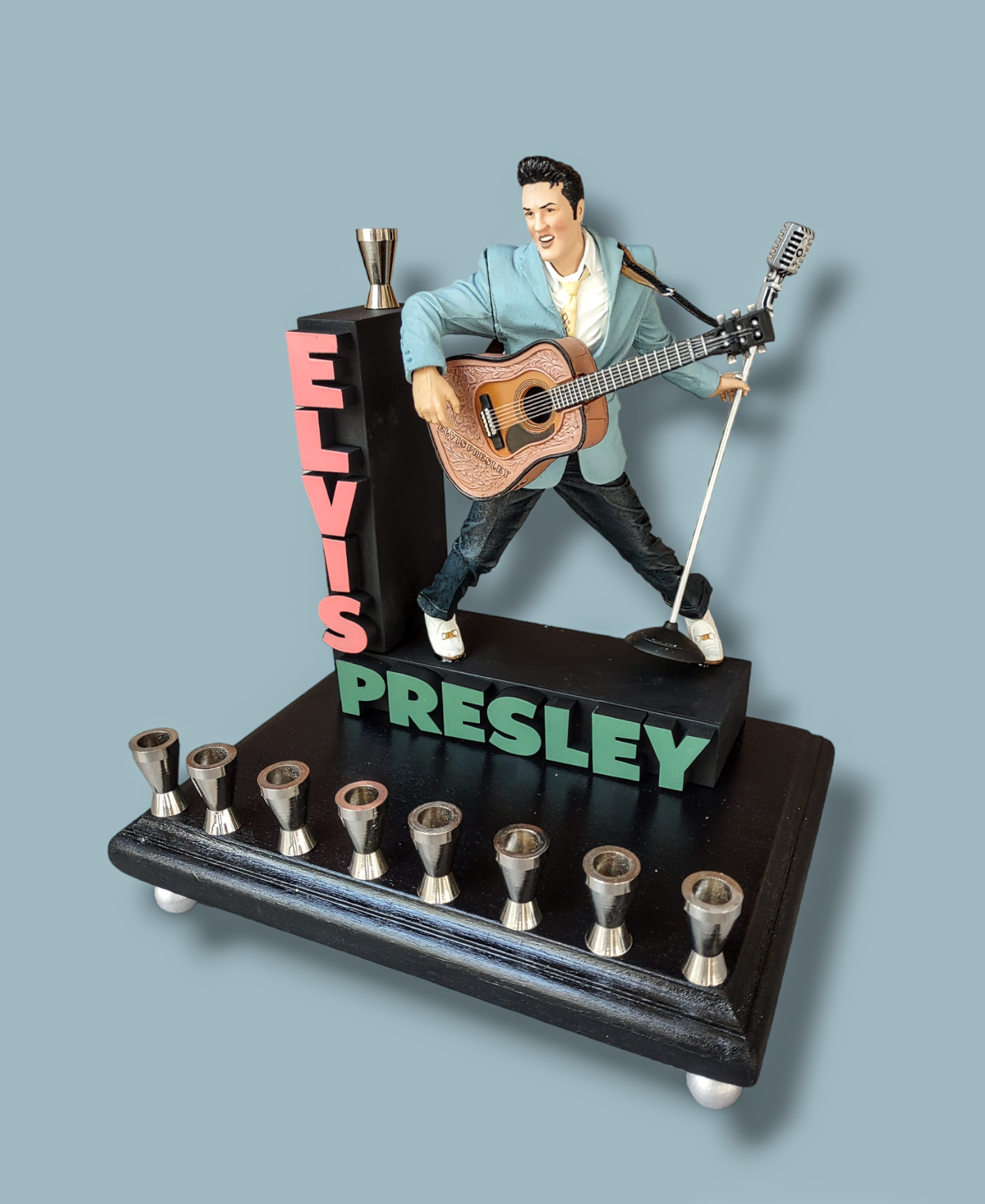 Elvis marquee menorah — King figure at the mic under a stacked name marquee | Judaica Square Lakewood (view 4)