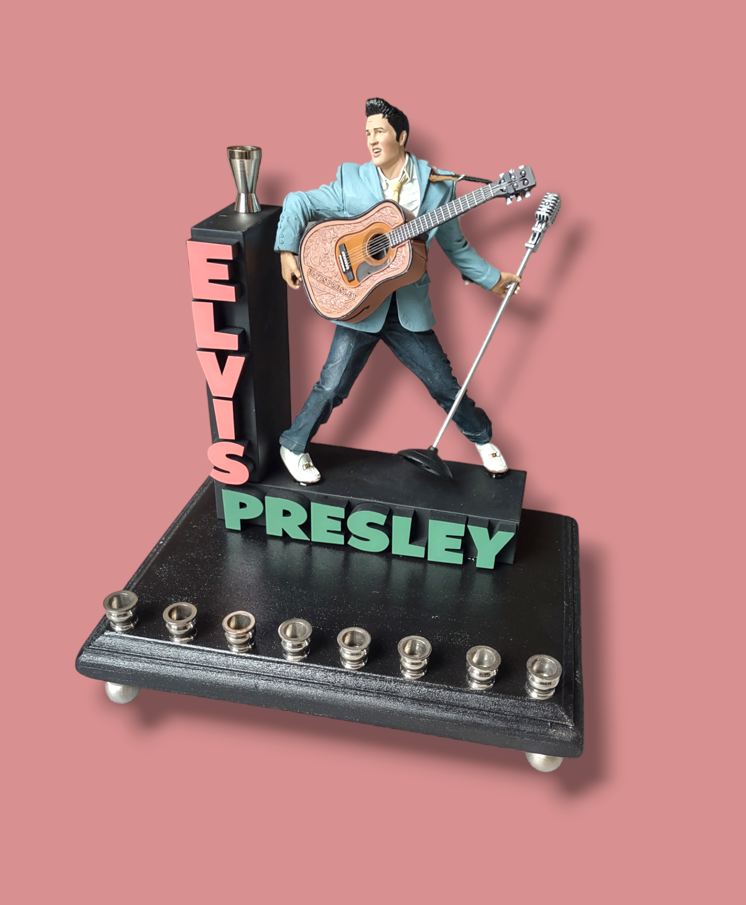 Elvis marquee menorah — King figure at the mic under a stacked name marquee | Judaica Square Lakewood (view 6)