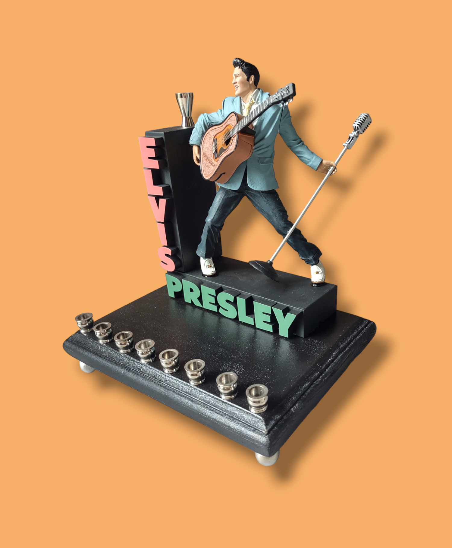 Elvis marquee menorah — King figure at the mic under a stacked name marquee | Judaica Square Lakewood (view 5)