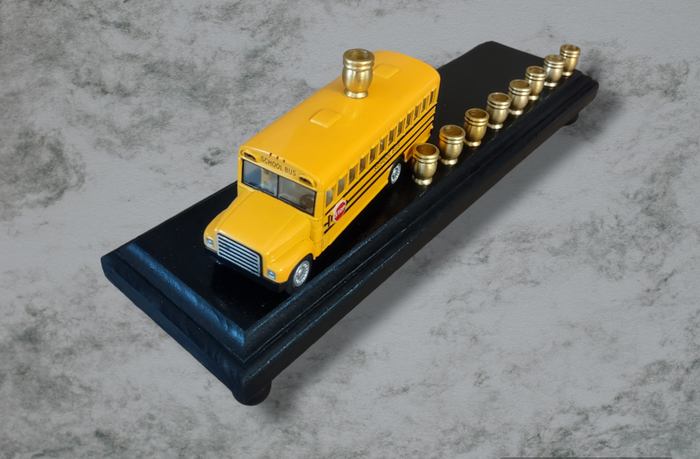 School Bus Menorah — yellow repurposed toy bus fitted with aluminum candle cups | Judaica Square Lakewood