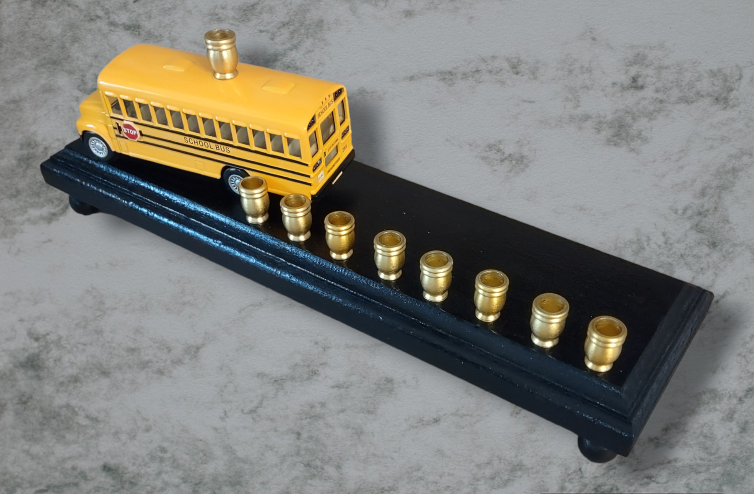 School Bus Menorah — yellow repurposed toy bus fitted with aluminum candle cups | Judaica Square Lakewood (view 2)