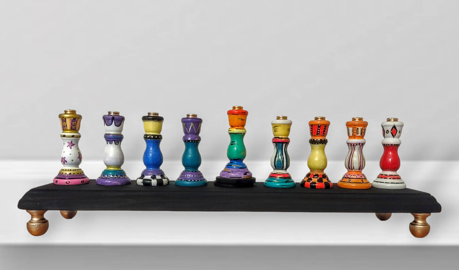 Colorful candlestick menorah — each tapered holder painted in a different pattern | Judaica Square Lakewood (view 2)