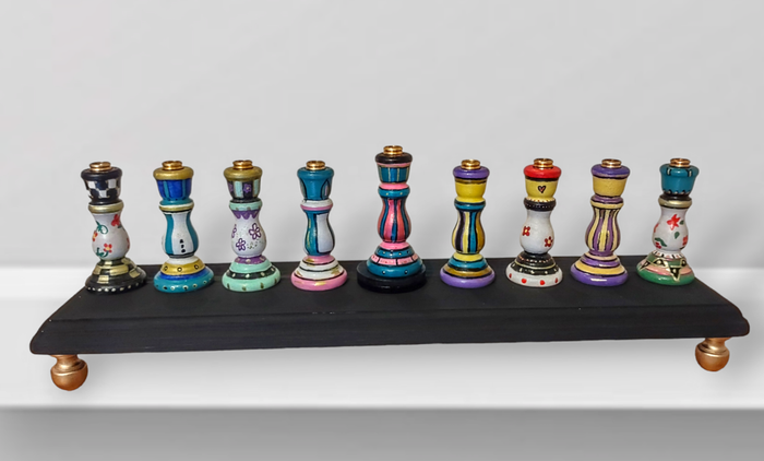 Colorful candlestick menorah — each tapered holder painted in a different pattern | Judaica Square Lakewood