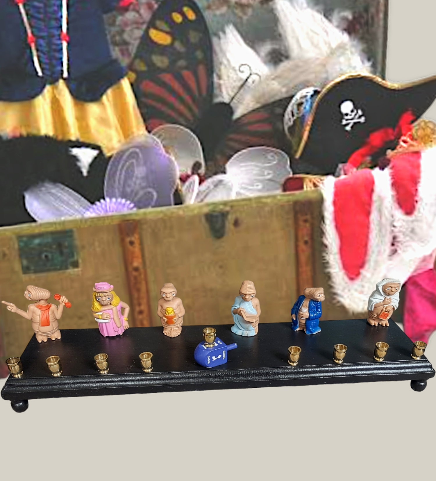 E.T. dress up menorah — six costumed E.T. toy figures along a painted plaque | Judaica Square Lakewood (view 6)