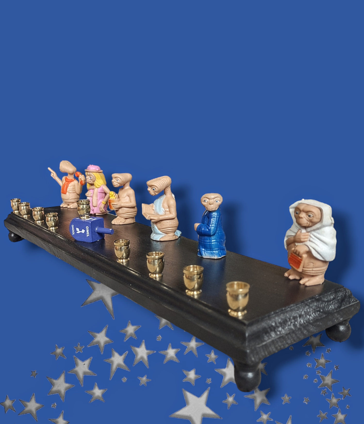 E.T. dress up menorah — six costumed E.T. toy figures along a painted plaque | Judaica Square Lakewood (view 4)