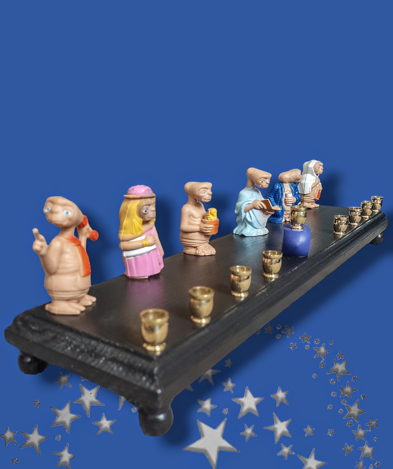 E.T. dress up menorah — six costumed E.T. toy figures along a painted plaque | Judaica Square Lakewood (view 3)