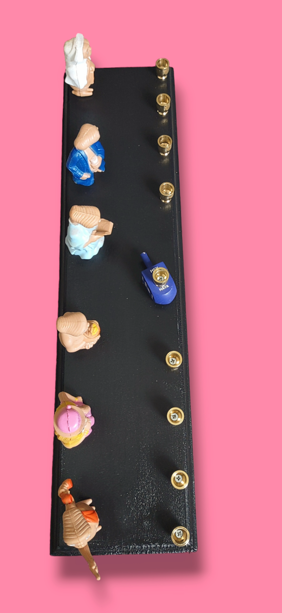 E.T. dress up menorah — six costumed E.T. toy figures along a painted plaque | Judaica Square Lakewood (view 5)