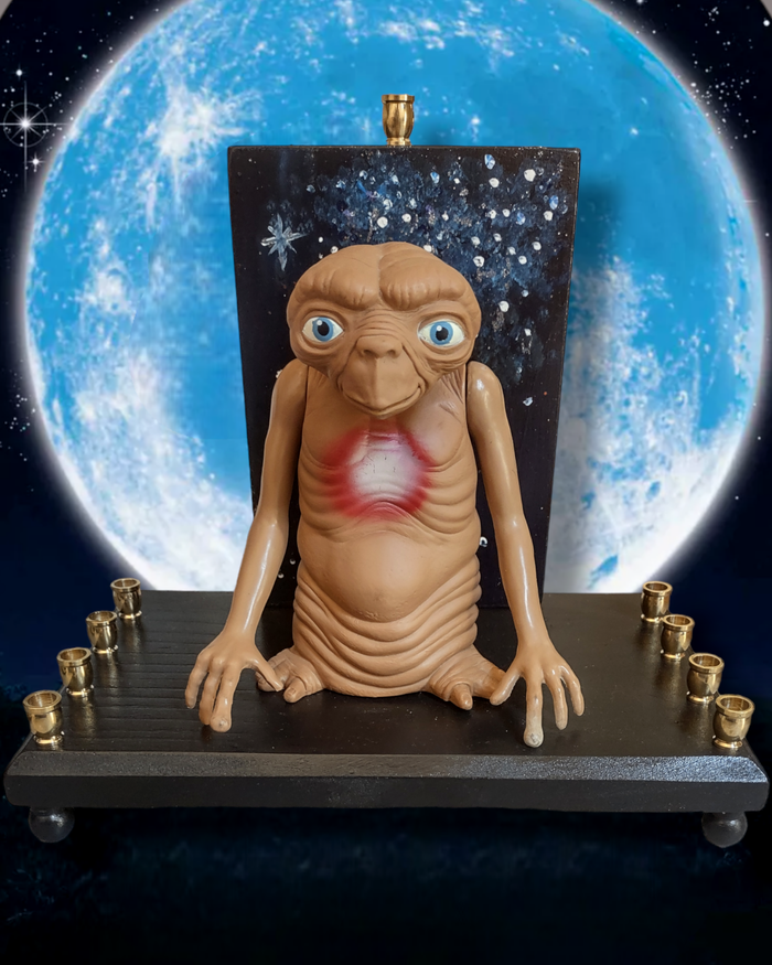 Giant E.T. Menorah — large alien figure above brass candle cups on wood | Judaica Square Lakewood