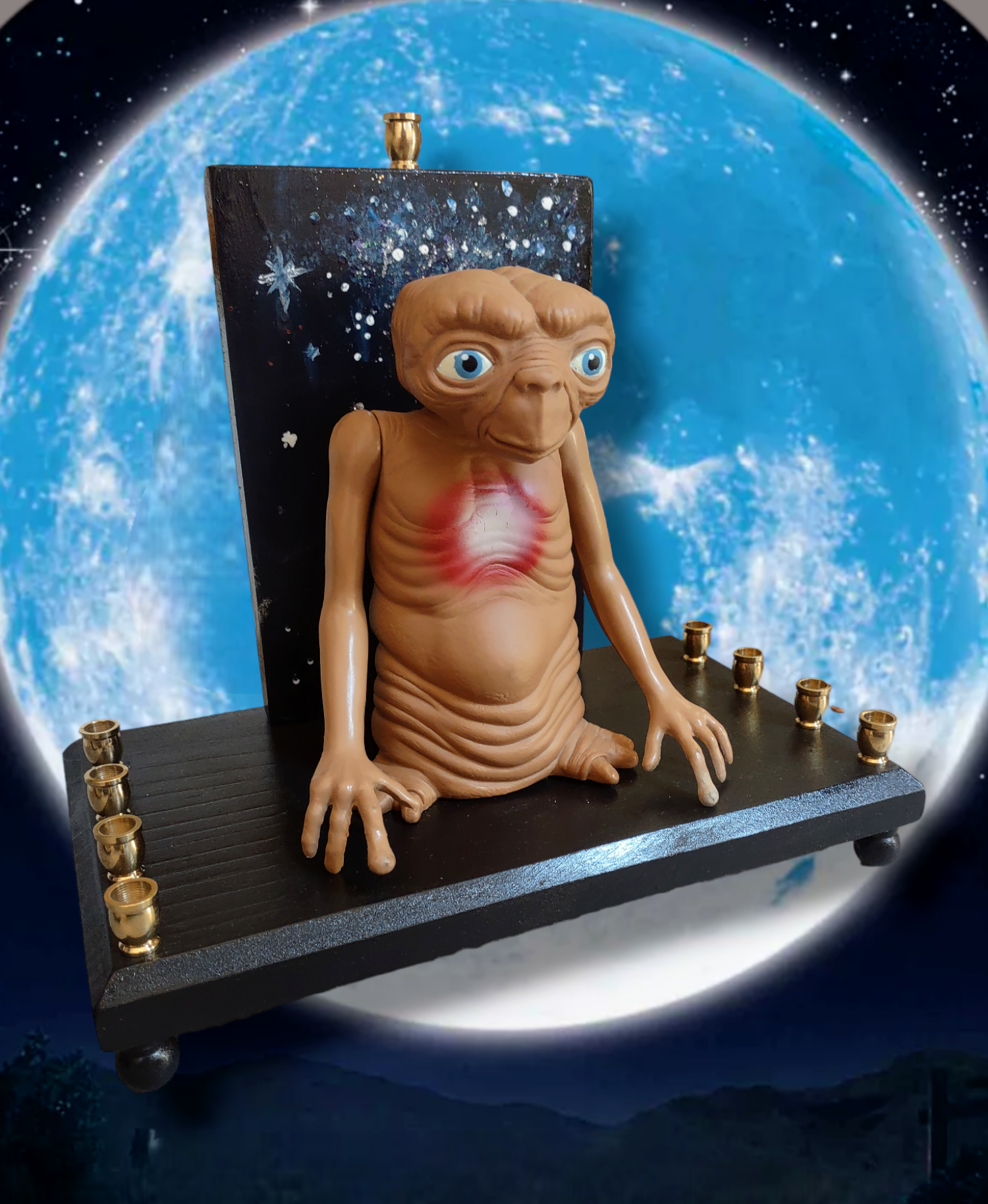 Giant E.T. Menorah — large alien figure above brass candle cups on wood | Judaica Square Lakewood (view 2)