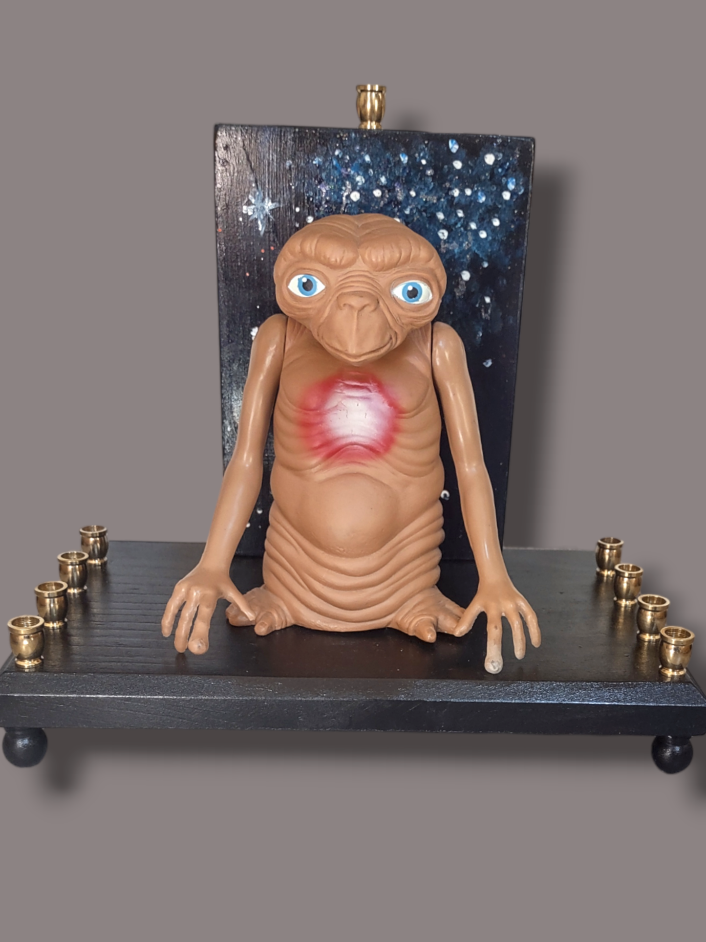 Giant E.T. Menorah — large alien figure above brass candle cups on wood | Judaica Square Lakewood (view 5)