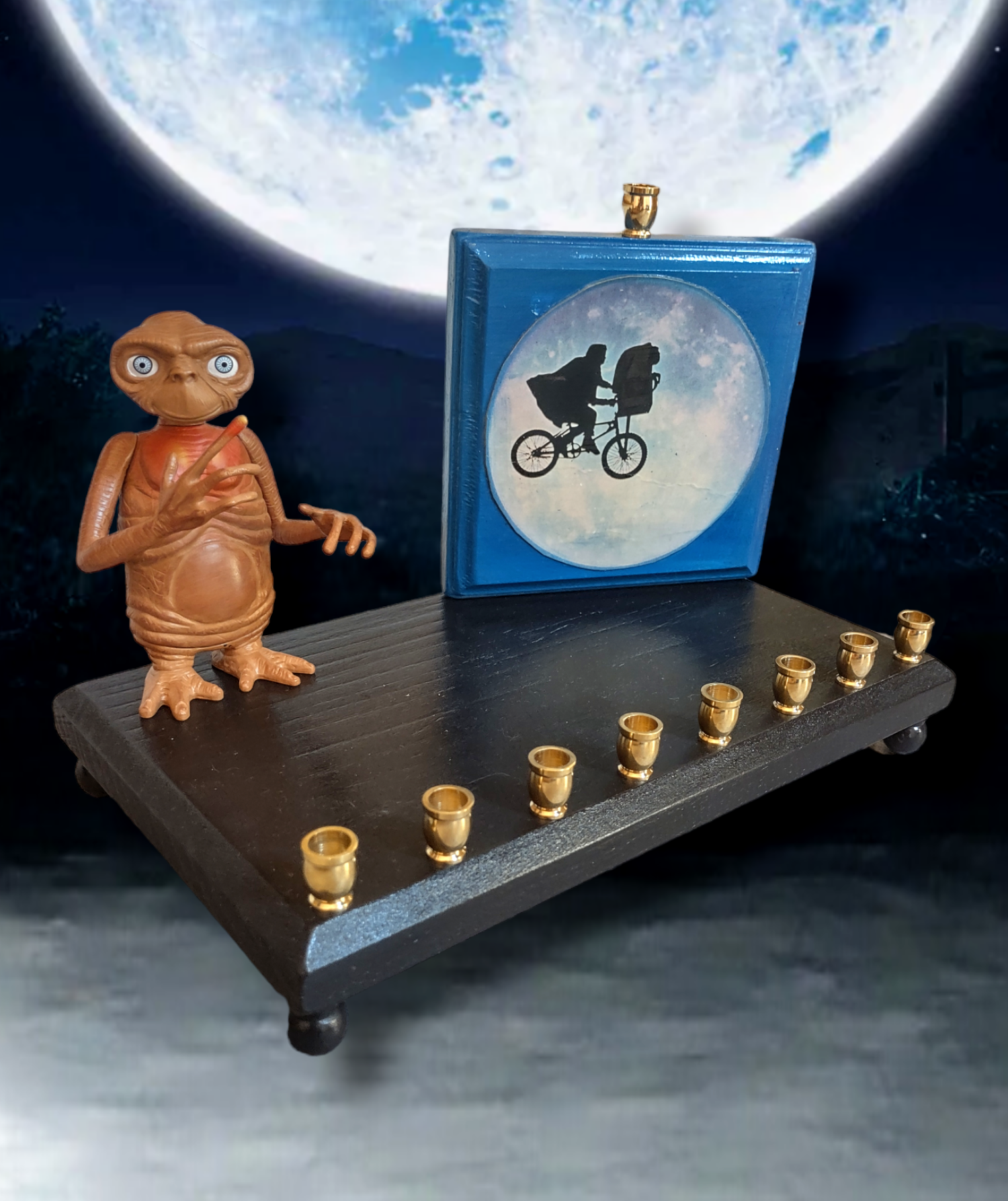 E.T. menorah — repurposed figure beside a hand-painted silhouette on wood | Judaica Square Lakewood (view 5)