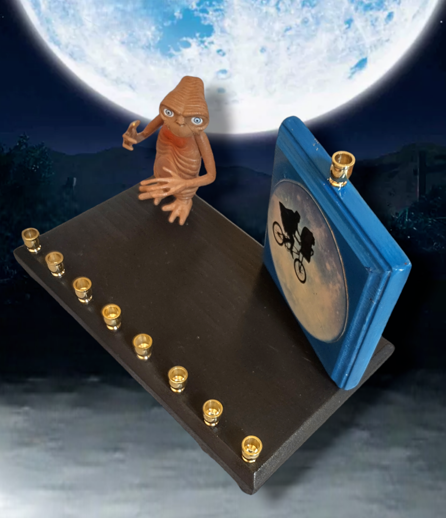 E.T. menorah — repurposed figure beside a hand-painted silhouette on wood | Judaica Square Lakewood (view 4)