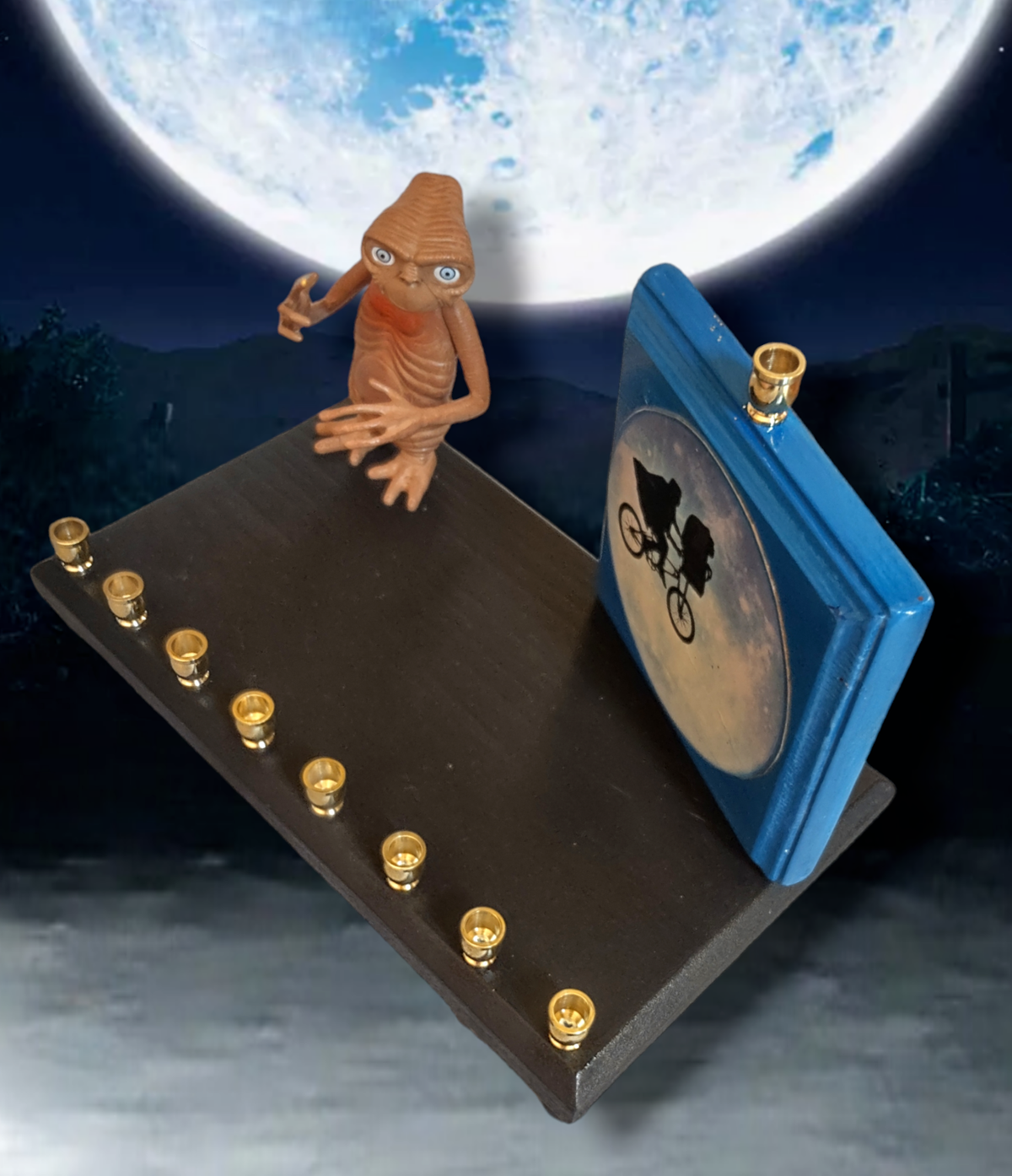 E.T. menorah — repurposed figure beside a hand-painted silhouette on wood | Judaica Square Lakewood (view 4)