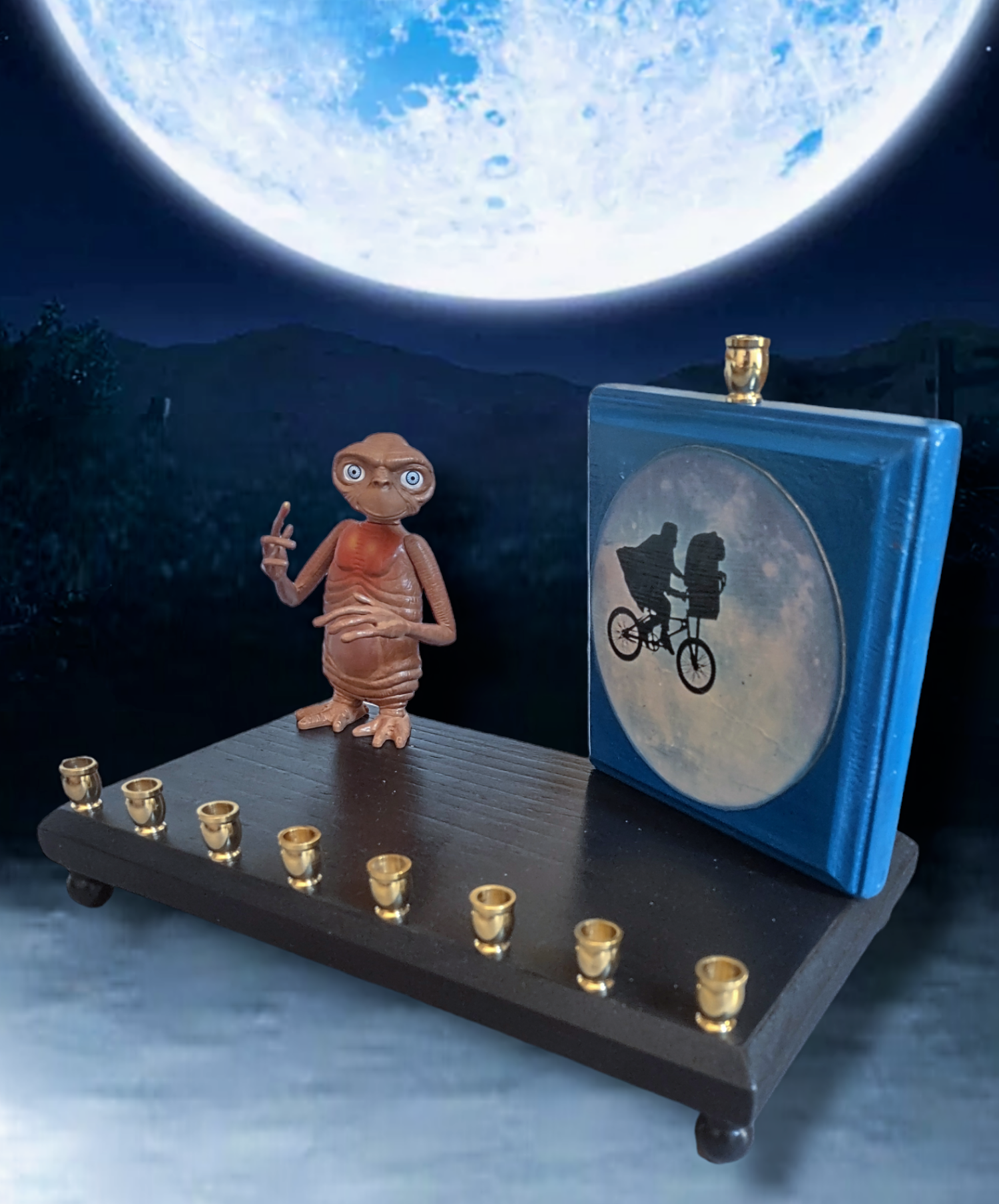 E.T. menorah — repurposed figure beside a hand-painted silhouette on wood | Judaica Square Lakewood (view 3)
