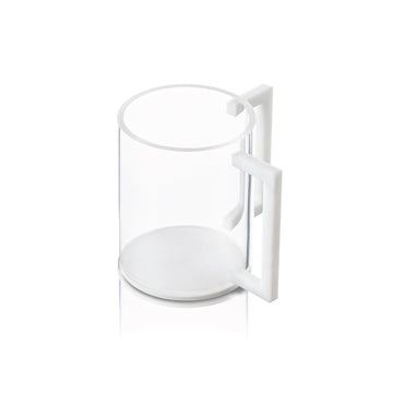 Clear lucite washing cup with a white marble base and squared white marble handles, shown at an angle