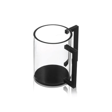 Clear lucite negel vasser cup with a black base and two squared black handles, shown at an angle