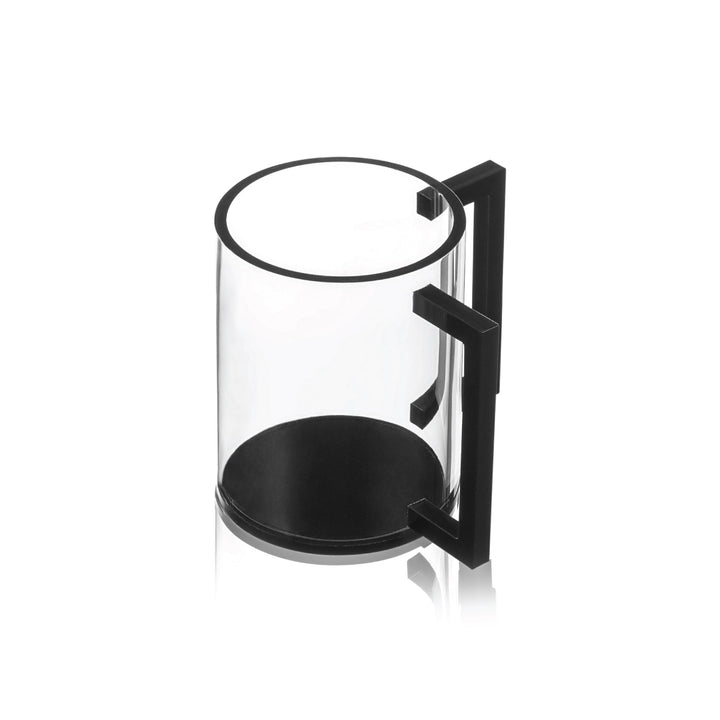 Clear lucite negel vasser cup with a black base and two squared black handles, shown at an angle
