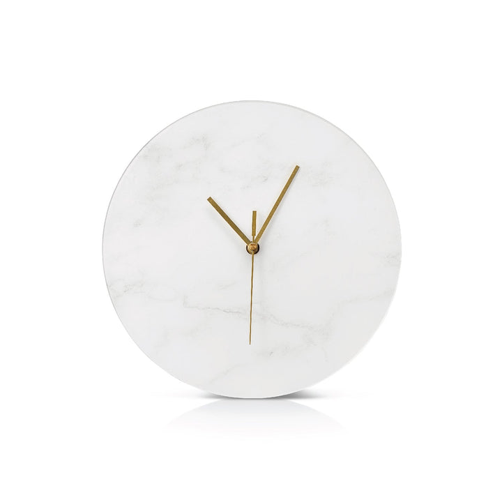 White marble clock face with slim gold hands, shown straight on