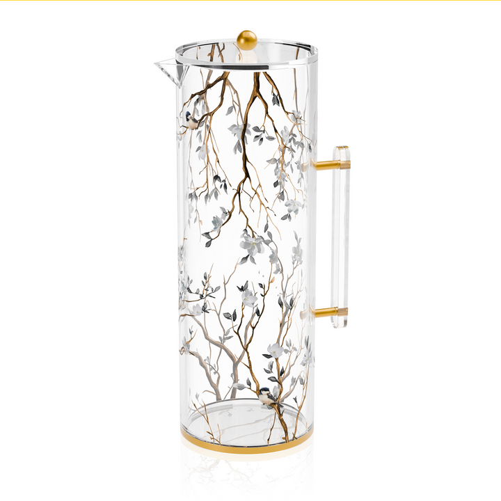 Clear lucite Botanical Blooms water pitcher shown from the side, the floral print wrapping the body between gold-trimmed rims
