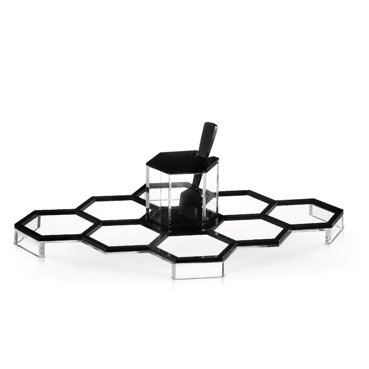 Black lucite honeycomb simanim tray with its centre honey dish in place, shown front on