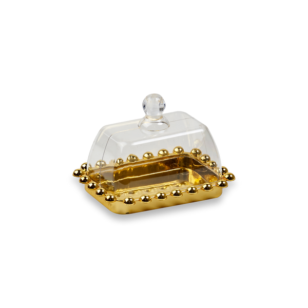 Small rectangular gold tray with beaded rim under a clear bell-shaped plastic lid with round knob