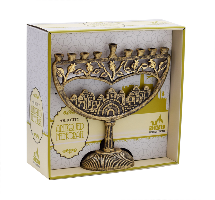 Antique gold aluminum menorah with an Old City of Jerusalem relief, shown in its windowed gift box