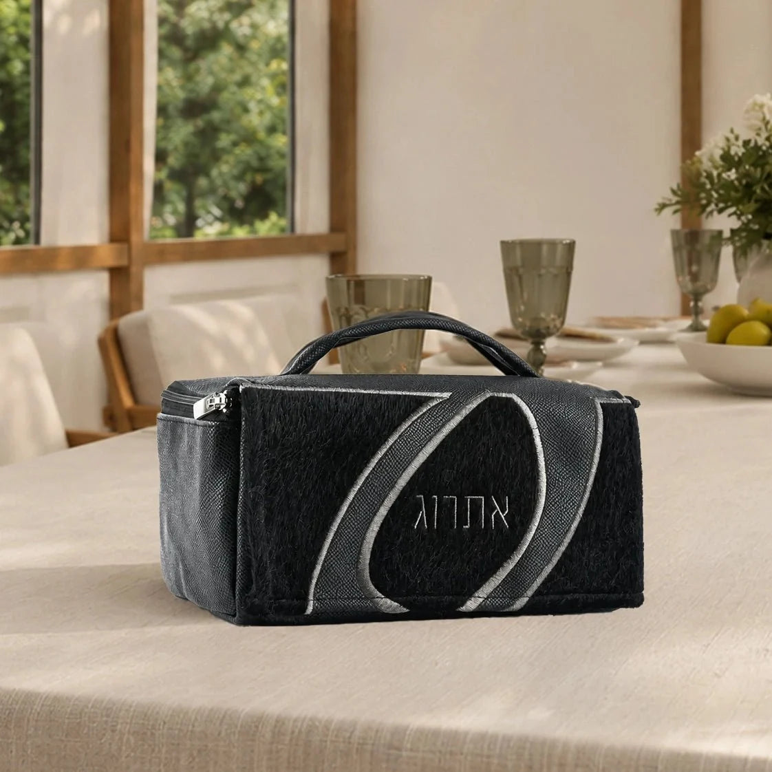 Black Waterdale esrog bag with carry handle on a dining table