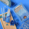 Handmade box of blue Chanukah candles with silver tips