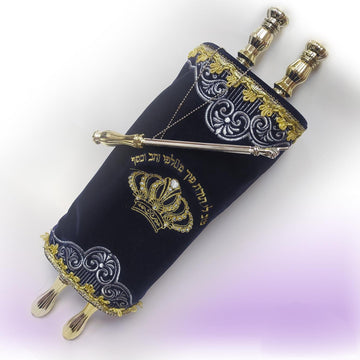 Blue velvet toy Torah with embroidered decoration, gold handles, and a silver-colored yad