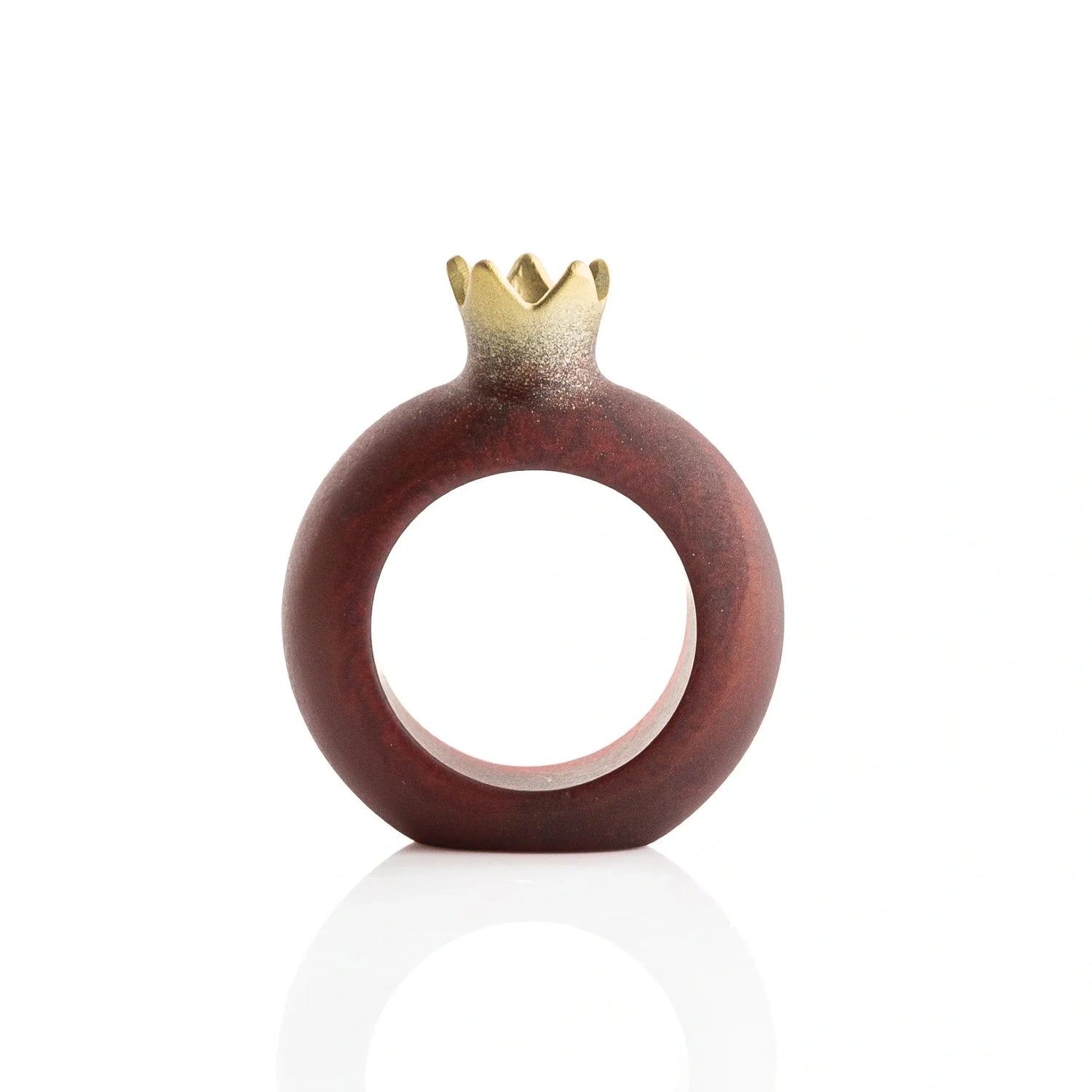 Single deep red resin pomegranate napkin ring with a gold-tone crown on a white background