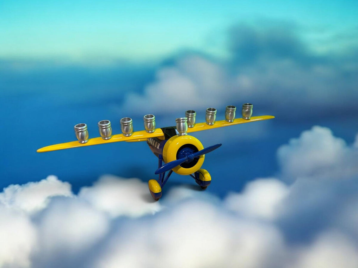 Yellow airplane menorah above clouds