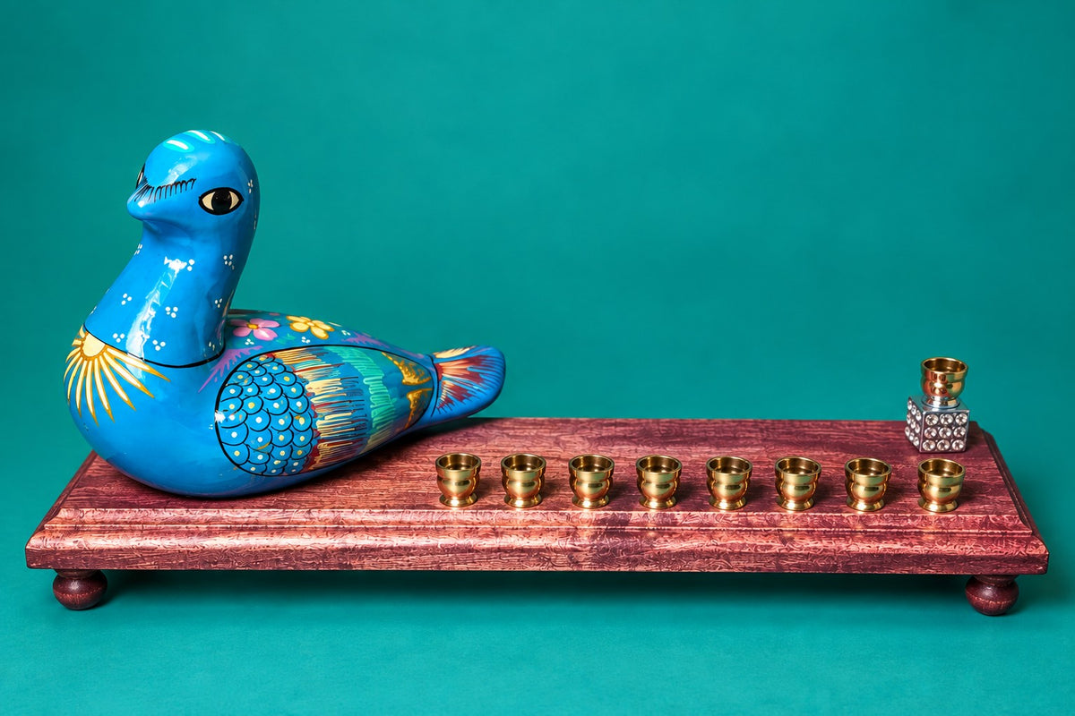 Blue painted ceramic bird on a wood menorah base