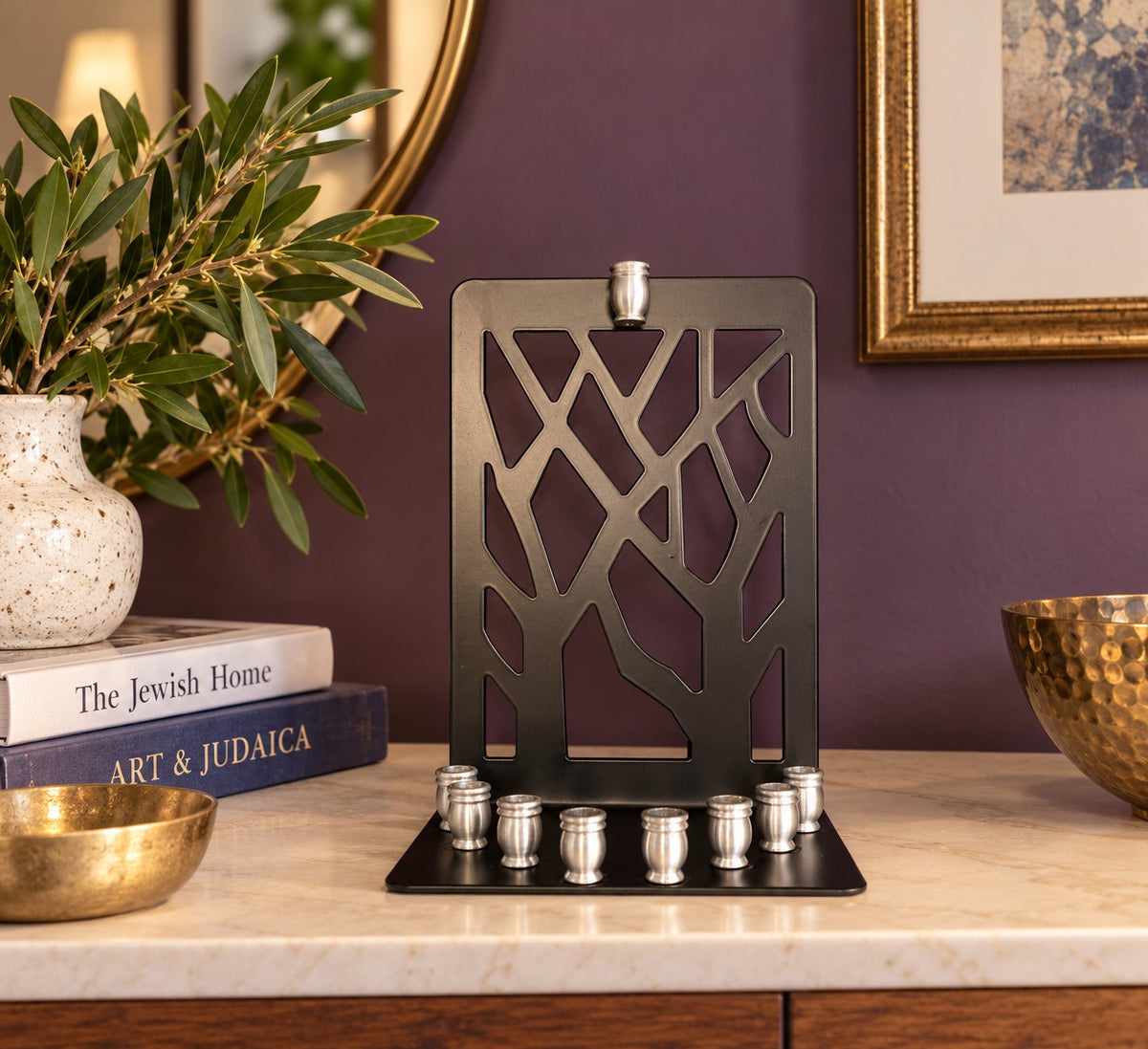 Branches menorah on a counter against a purple wall