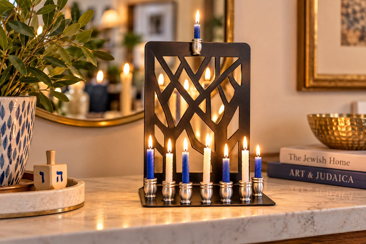 Branches menorah with blue and white candles lit on a counter