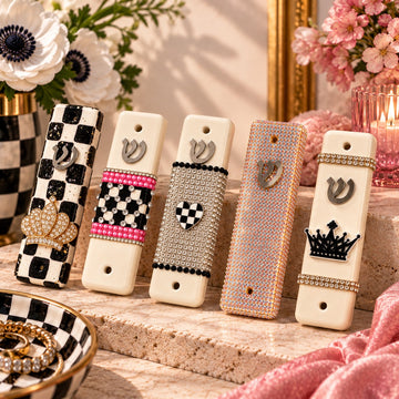 Row of checkered and charmed ceramic mezuzah cases