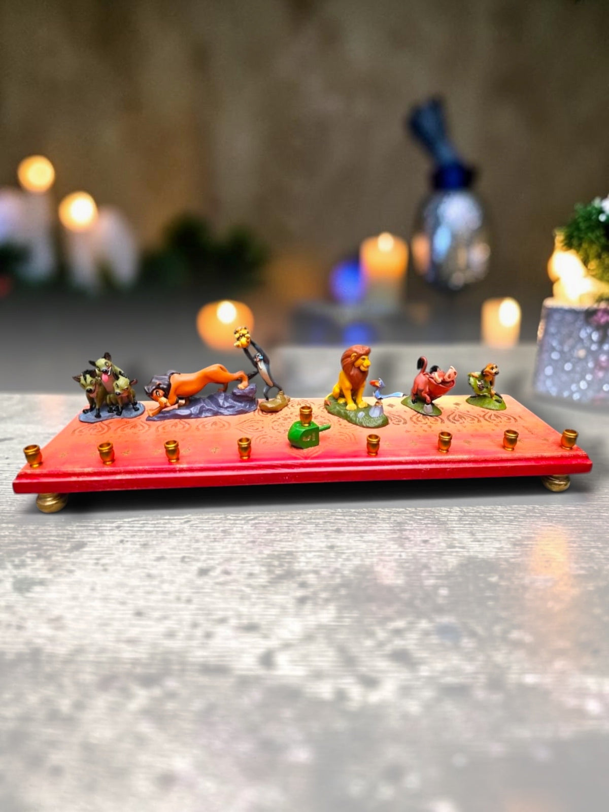 Collector’s Edition Lion King “Circle of Life” Menorah, full-length view of the Circle of Life menorah with lit candles…