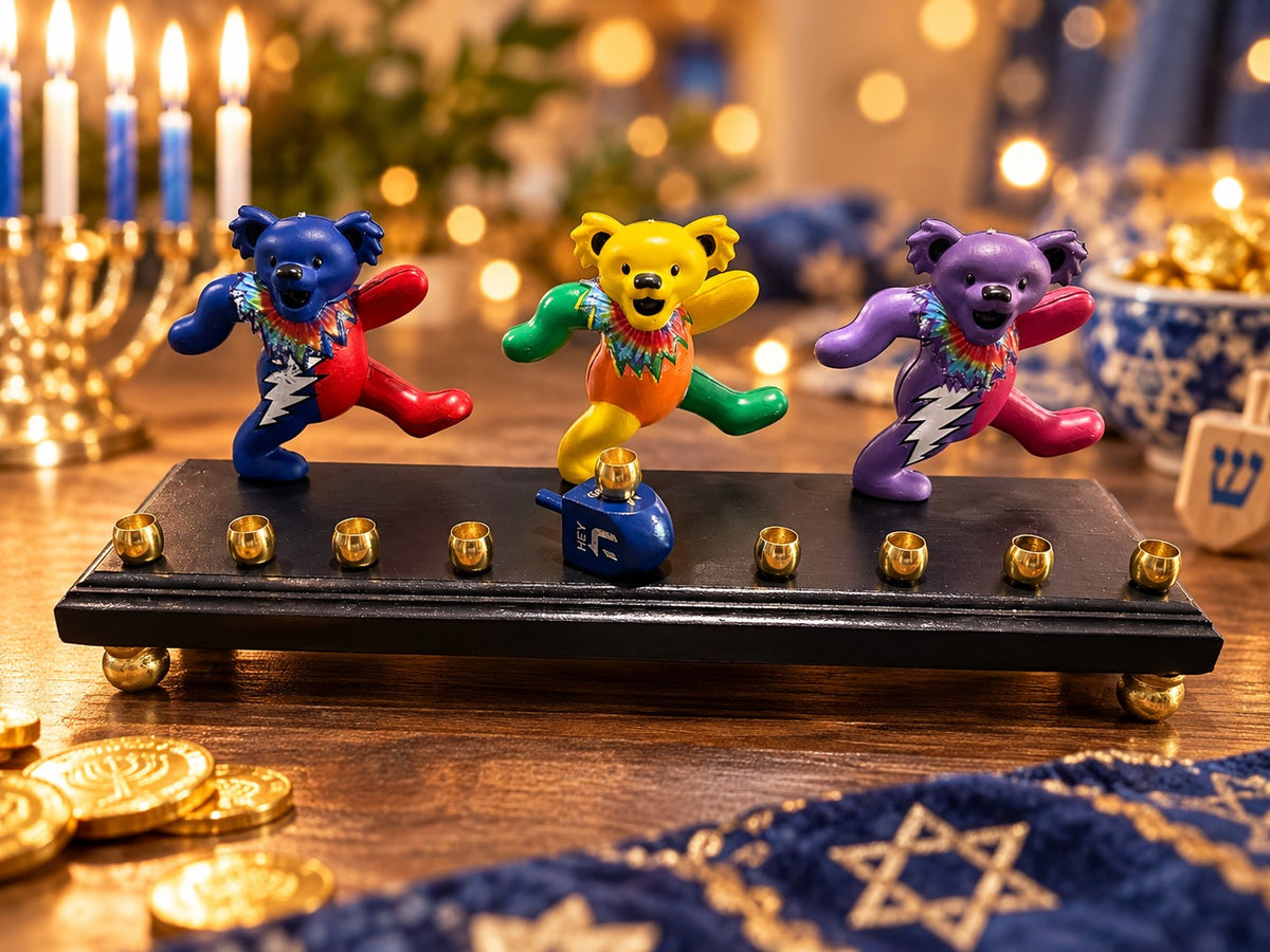 Dancing bears menorah with lit candles on a table