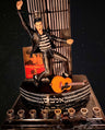 Elvis Presley Menorah, Elvis figure with guitar on a stage-style base with candle cups, dark backdrop
