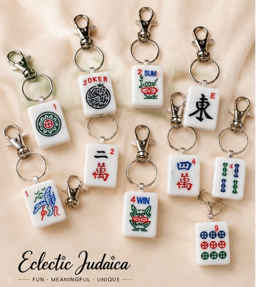 Assorted Mah Jong tile keychains with Eclectic Judaica logo